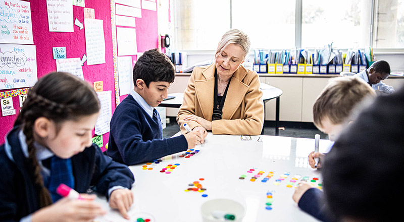 Teacher supporting students at St Patrick's Catholic Primary Blacktown
